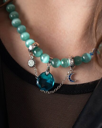 LunaSol Necklace featuring Tiffany cat-eye stones, a majestic blue Swarovski crystal, and a sterling silver moon and sun motif pendant