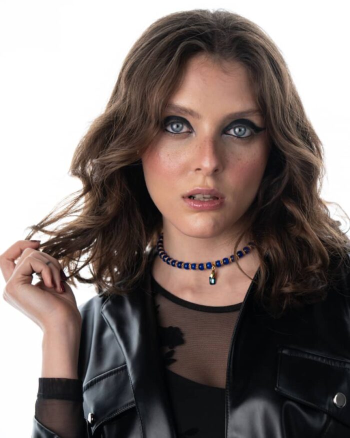 A handcrafted Egypt-Inspired Dark Blue Necklace featuring cat’s eye stones, Swarovski crystals, and black accents.