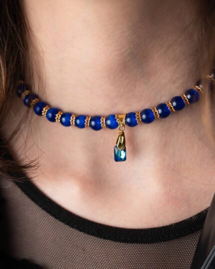 A handcrafted Egypt-Inspired Dark Blue Necklace featuring cat’s eye stones, Swarovski crystals, and black accents.